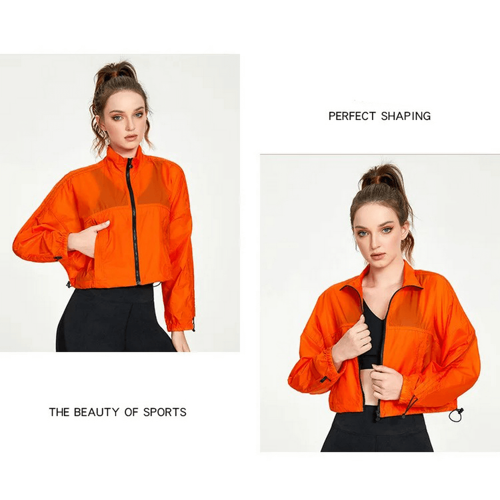 Woman models vibrant orange neon windbreaker jacket; stylish and breathable for outdoor activities.